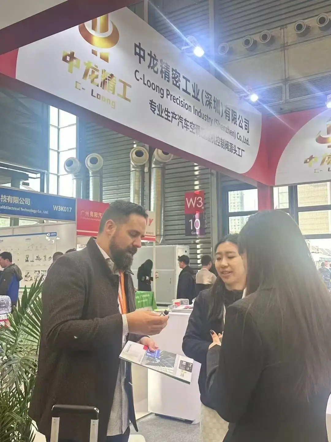 C-Long Precision Industry team meeting customers at an automotive industry trade show